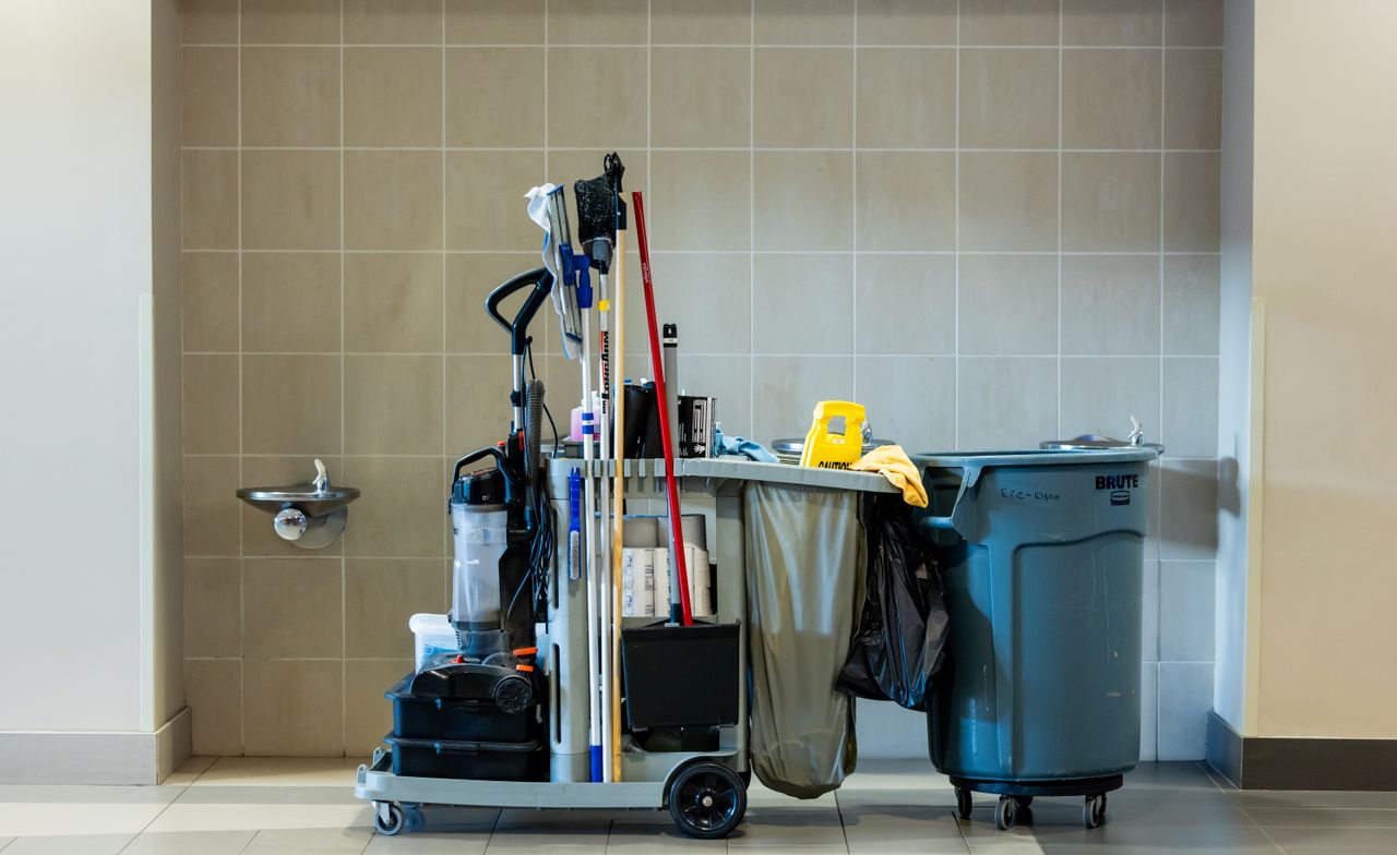 Home A comprehensive collection of professional cleaning tools on a cart in an indoor environment.